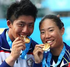 Taiwan&#39;s tennis players Lee Hsin-han (left) and Chan Chin-wei taste gold Aug. 21 after defeating the Belarusian team in the mixed doubles final. (CNA) - 182213593571