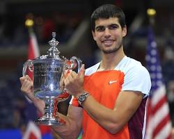 Image of Carlos Alcaraz holding the US Open trophy