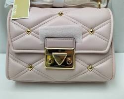 Image of quilted leather crossbody bag in a soft blush pink color