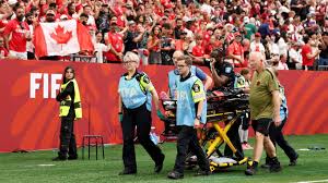 Canada's Ismaël Koné stretchered off after hard tackle