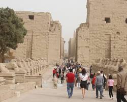 Image of grand procession of priests carrying a statue of AmunRe through Karnak Temple, symbolizing the god's presence and the interaction between the divine and the human.