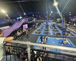 Image of Someone dunking a basketball on a trampoline court at Ninja Kidz Action Park Hammond