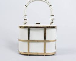 Image of cage bag with a gold metal frame and black leather interior