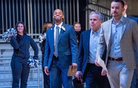 Brad Stevens congratulates former player Ronald Nored on becoming Butler basketball coach