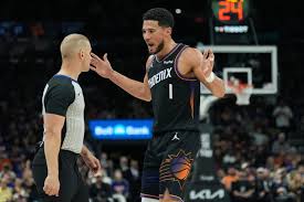 Suns' Booker hurts ankle after tripping over Dort's foot, says he doesn't know if it was on purpose