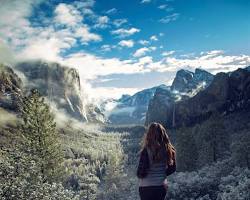 Image of hiker standing at Tunnel View, Yosemite National Park, looking out at the valley