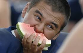 Thomas Pineda, above, eats three pieces of watermelon at once after practice ... - EP-708259570