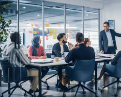 Image of diverse group of young Indian entrepreneurs brainstorming in a modern office, not copyrighted