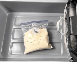 domestic flight cabin with a person holding a protein shakerの画像