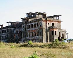 The eerie, abandoned Bokor Palace Hotel on a misty day.