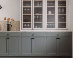 Image of kitchen with wood upper cabinets and glass lower cabinets