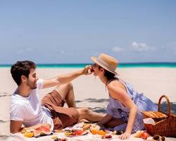 Hình ảnh về Couple having a picnic at the beach