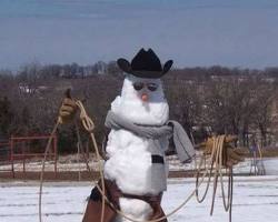 Image of Texans building snowman with cowboy hat