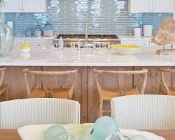 تصویر kitchen with cream cabinets and a light blue backsplash