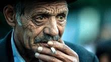 An elderly Romanian Roma man smokes after he and more than 200 others ... - dip1409-05-roma