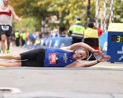person crossing a finish line after a marathon