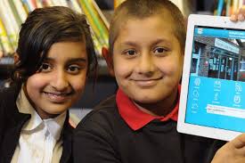 Joseph Cash Primary School in Radford, Coventry, has launched its own smartphone app. Left to right: pupils Saphia Bahar and Amaan Khan, both 10 - smartphone-app-521794472