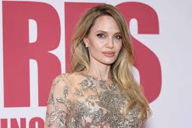 Angelina Jolie Stuns Pairing a Bold Bright Red Lip With a Silky White Wrap Dress