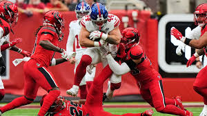 Cam Skattebo runs with the football during a Giants game against the Texans