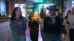 Molly Vigen, the First Lady of Bobcat Football line dancing to a Bobcat Victory