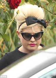 Saying goodbye: Kelly Osbourne - wearing a beehive in tribute to her friend - and friend Remi Nicole arrive at Amy Winehouse&#39;s funeral this afternoon - article-2018929-0D2BC1F100000578-653_306x423