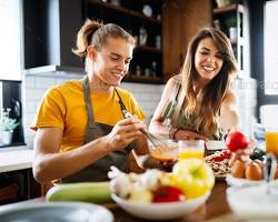 Image of person happily cooking in their kitchen