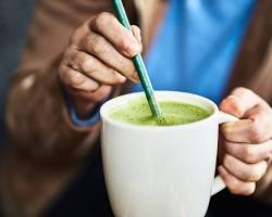Image of person studying with a matcha latte