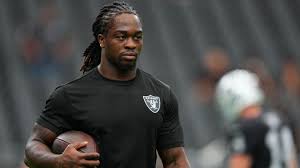 Ashton Jeanty running with the football during a Raiders game