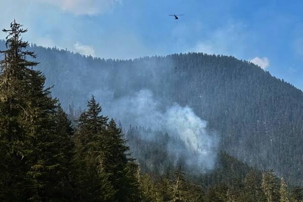 Wildfire in British Columbia's Okanagan forces 20,000 to flee; premier says speed may signal 'new normal' as blaze grows to 184 sq km