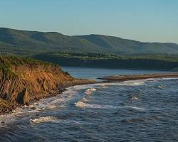 Image of breathtaking Canadian coastline with dramatic cliffs and crashing waves