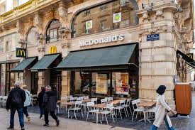 McDonald's trades lower after reporting soft global sales; improvement seen 
in the U.S.