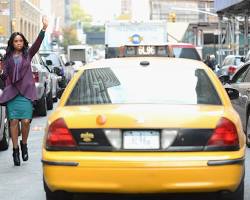 Image of person hailing a taxi in New York City