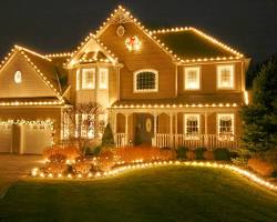 House beautifully decorated with Christmas lights by Amco, showcasing twinkling rooflines and illuminated landscaping, embodying festive holiday spirit.