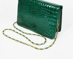 Image of croc embossed leather clutch in a bold emerald green color