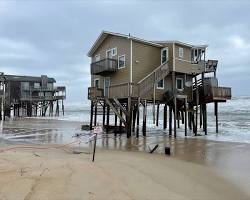 Image of Outer Banks' shoreline with colorful beach houses on stilts