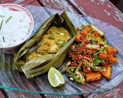 Image of Amok, a traditional Khmer fish curry, served in a banana leaf bowl