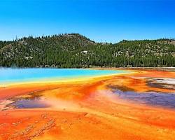 group of visitors admiring the Grand Prismatic Spring in Yellowstone National Park