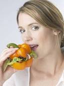 Stock Photography of Woman with an orange pepper burger u22090760 - Search ... - u22090760