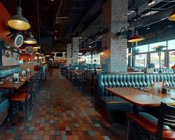 modern cafe interior with spacious seating and comfortable chairsの画像