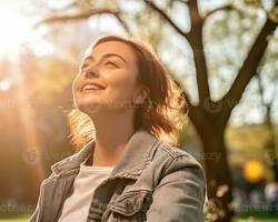 Image of Person enjoying sunlight in a park