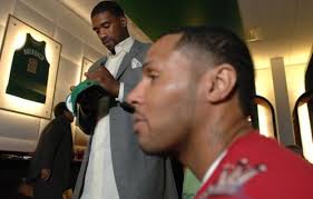 Leon Powe signs a cap as Eddie House, right, looks on at the Celtics DVD release party. (Josh Reynolds / For the Globe). E-mail to a friend - 499w