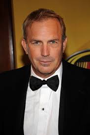 Kevin Costner  - 2024 Dark brown hair & Caesar hair style.
