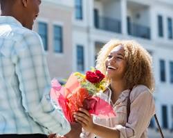 Image of person giving flowers to another person