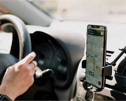 Image of person checking license plate on smartphone app taxi