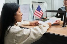 Applicant submitting green card documents at a visa center