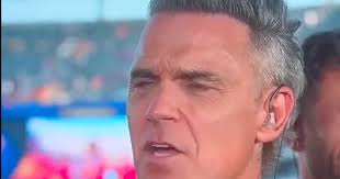 Robbie Williams addresses World Cup final TV incident after white object falls from mouth