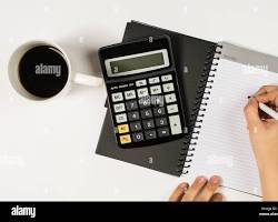 Image of student surrounded by textbooks, calculator, and coffee