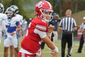 Marshall Manning playing football during a high school game