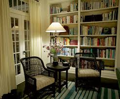 A living room filled with furniture and a book shelf.