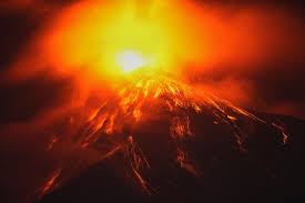 Fuego volcano erupting with lava and ash above Guatemala communities